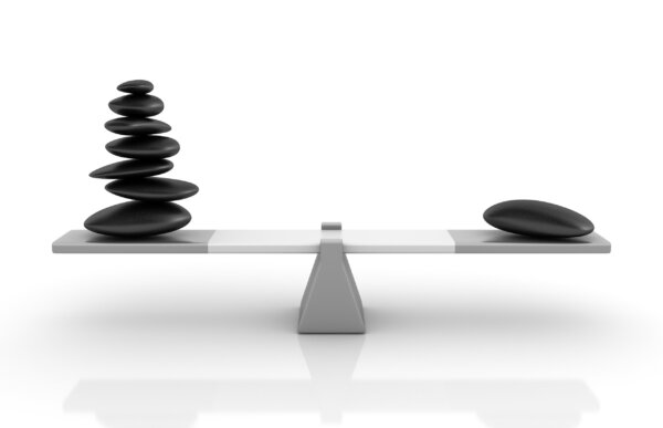 Monochrome image of balancing scales with several stones on one side, evenly balanced with one on the other, as illustration for post 'SALARY and DIVIDEND still best?'