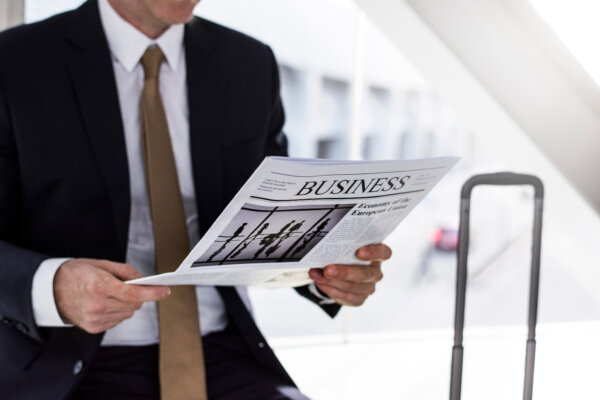 An image of a Business man in collar and tie reading a business newspaper as illustration for post 'Increase to small company thresholds'.