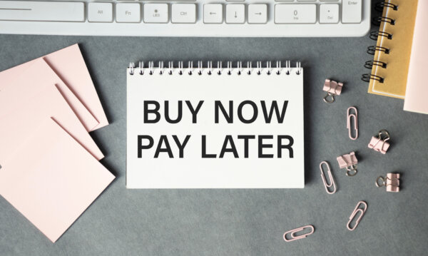 An image of a notepad on a desk with the words 'Buy now, pay later' printed on it as illustration for post 'Buy Now, Pay Later Regulation changes'