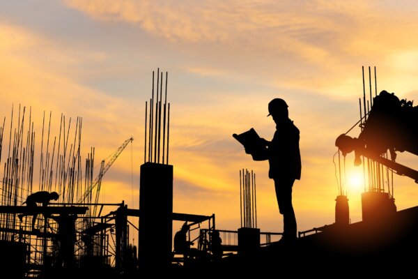 Image of construction worker silhouetted against a sun rise as illustration for post 'Possible reform of the Construction Industry Scheme (CIS)'.