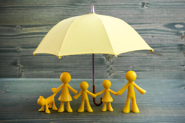 Image of four yellow plastic models of people under a yellow umbrella as illustration for post 'HMRC Financial Support Guide'