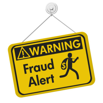 Image of a yellow hanging sign with the wording 'Warning Fraud alert' in black text, as illustration for post 'BEWARE! VAT Fraud warning.'