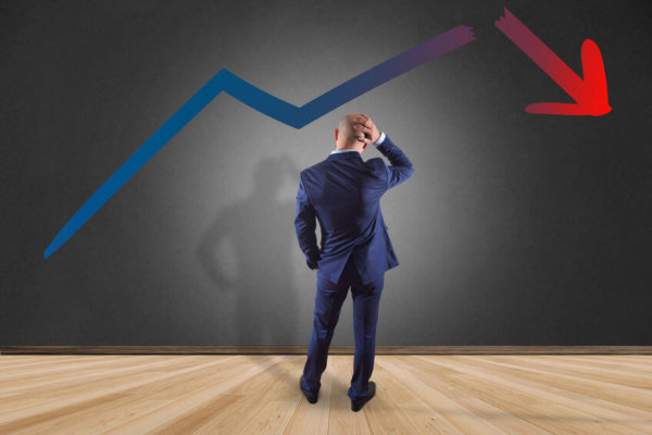 Image of man in front of a declining graph for Blog post 'Is your business 'Growing Broke'?'