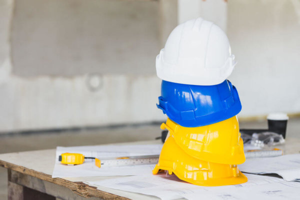 Image of hard hats piled up on a table, as illustrations for Blog Post 'Domestic Reverse Charge VAT delayed'