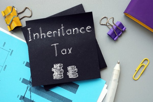 Image of Post it note with 'Inheritance Tax' written on it with other desk stationery items around it as illustration for post 'Inheritance Tax Receipts Increase'