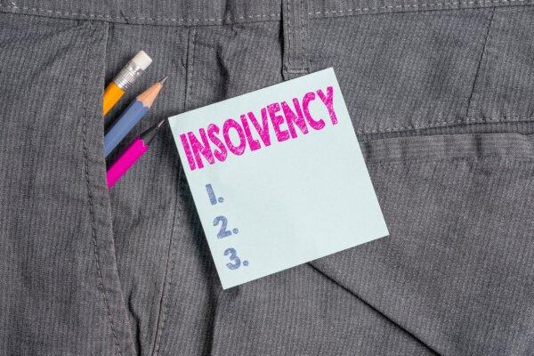 Image of a sticky note with the word 'Insolvency' and three bullet points with pens and pencil as illustration for post 'Insolvency up by 16.5% on last year'.