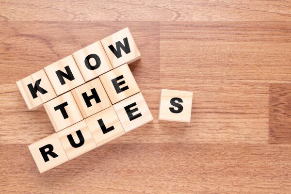 Image of children wooden blocks spelling out 'Know the rules' as illustration for post 'What are 'Associated Companies' in 2023?'