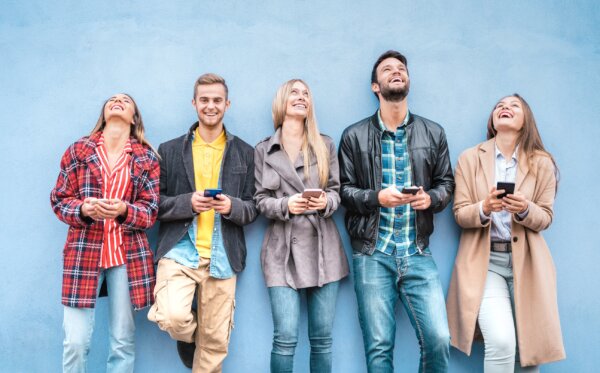 Image of five casually dressed young adults with smart phones as illustration for post 'GenZ and their phone aversion!'