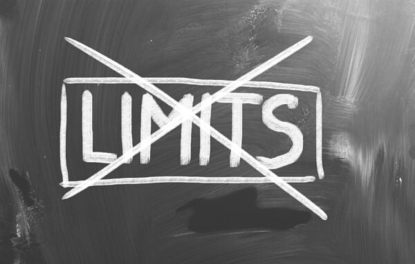Image of'Limits' written in chalk and crossed through as illustration for post 'HMRC removes PAYE Self Assessment Threshold'.