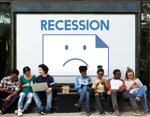 Image of young people on a bench in front of a sign with an unhappy emoji with 'Recession' above it, as illustration for post 'Navigating recession: What to do NOW! '