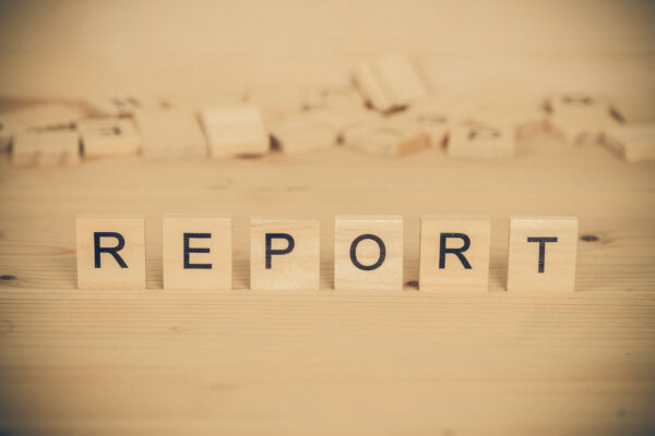 An image of Scrabble tiles spelling out 'Report' with a pile of spare tiles in the background, as illustration for post 'Report on Companies House progress released'