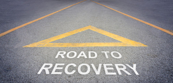 Image of a road with white lining spelling out 'Road to Recovery' as illustration for Blog post 'Coronavirus Economic Recovery Package to come...'