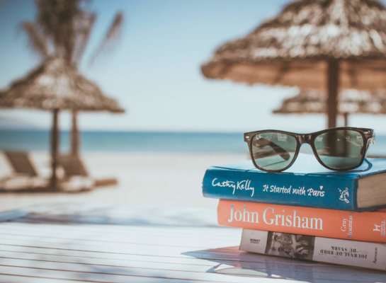Image of sunglasses and books on the beach as image for Blog post 'Time to Ponder'.