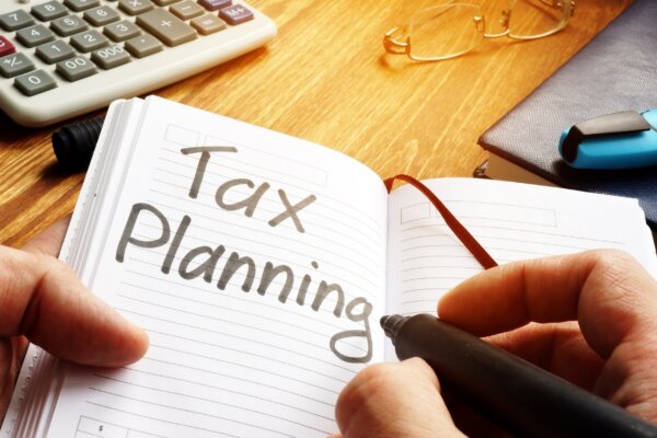 Image of an notebook with 'Tax Planning' written in large letters as illustration for post 'Year End Tax Guide 2022/23'