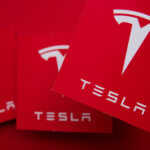 Multiple copies of the Tesla logo as illustration for Post 'How does Company Car Tax Work?'