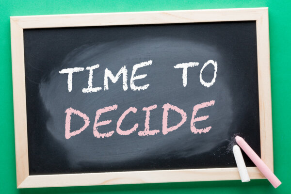 An image of a blackboard with 'Time to decide' written on it as illustration for post 'Should Small Businesses still use the VAT Flat Rate Scheme?'