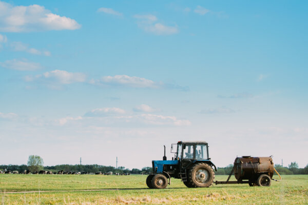 An image of a tractor and farm trailer as illustration for post 'Agricultural and business property relief: What happened in the Budget?'