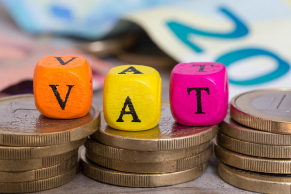 VAT spelt out in blocks on top of piles of coins as illustration for post 'VAT Flat Rate Scheme changes'