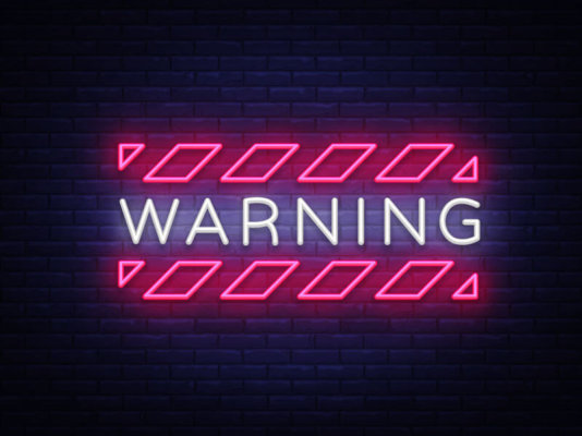 Image of neon sign saying 'Warning' as illustration for blog post 'Furlough Scheme Deadline Looming!'