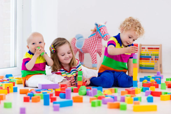 Image of children playing happily as image for blog post around Childcare Choices Government childcare scheme