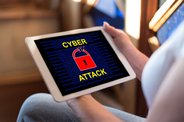 Image of an iPad with a Cyber Attack warning on the screen as illustration for post 'Consultation opened on cyber governance code for businesses'.